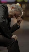 Somber Reflection A Pensive Man in Deep Thought Amidst a Busy Urban Setting of Life video