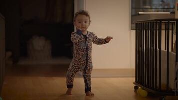 A cute toddler is joyfully playing while wearing colorful pajamas that are adorable and comfy video