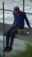 A Relaxed Professional Working Efficiently at the Beautiful Waterfront While Using a Laptop video