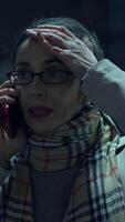 An Anxious and Concerned Woman on the Phone in a Dark Environment Within an Urban Cityscape video