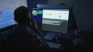 Dedicated and Focused Professional Expertly Analyzing Complex Data on Dual Monitors for Insights video