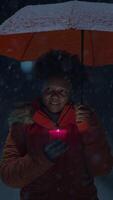 A Candlelight Vigil Taking Place in Snowy Weather, People Gather Under an Orange Umbrella video