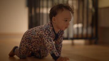 A Curious Toddler is Joyfully Crawling All Around Indoors While Wearing Cozy Pajamas Comfortably video