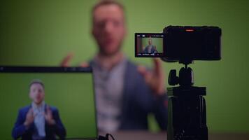 Professional Speaker Recording Session Conducted in Front of a Green Screen Setup video