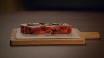 A Fresh Raw Meat Steak Is Placed on a Rustic Wooden Cutting Board for Preparation and Cooking video