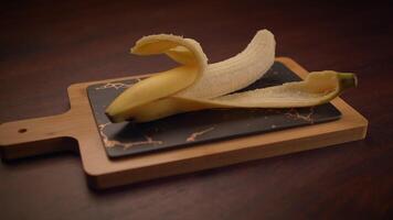 A Captivating Artistic Presentation of a Banana Arranged on a Beautiful Cutting Board video