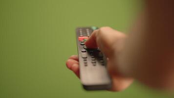A hand holds a remote control for easy access to entertainment options, enhancing experience video