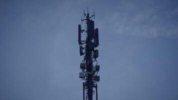 A tall telecom tower stands against a clear sky, symbolizing modern connectivity video