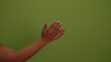An Artistic Hand Gesture Presenting Itself Against a Bright Green Background Setting video