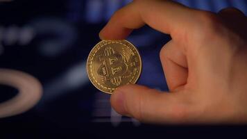 A hand is holding a shining golden coin within a sophisticated and modern digital environment video