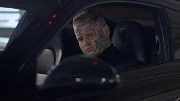 A Mysterious Individual Found Inside a Car Displaying Intriguing and Unique Tattoos video