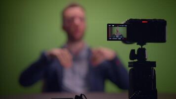 A complete professional filming setup featuring a presenter utilizing a green screen backdrop video