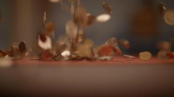 Coins As They Fall on a Surface in a Soft Focus Setting, Capturing Light and Motion video