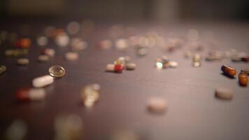 A Variety of Different Assorted Capsules and Pills Scattered Randomly Across the Table Surface video