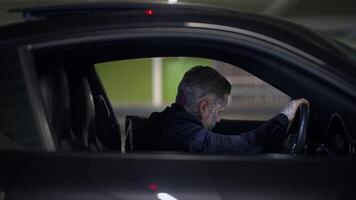 A Mysterious Driver Is Present in a Dimly Lit Parking Garage with an Intriguing Ambiance video
