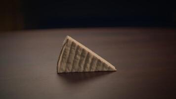 A Stunning Artistic Presentation of a Classic Triangular Piece of Cheese on a Charming Table video