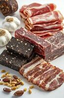 Group of Meat Products with Bacon, Black Bread, Pine Nuts, and Garlic on White Background photo