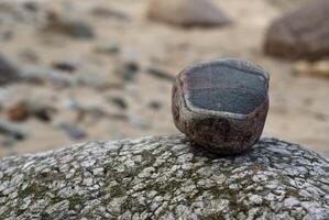 Textured Multicolor Stone on Weathered Rock in Coastal Setting photo