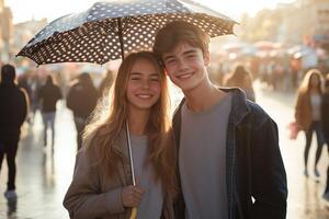 A smiling young couple standing under a navy polka dot umbrella in a sunny city square, with a vibrant and bustling atmosphere in the background photo