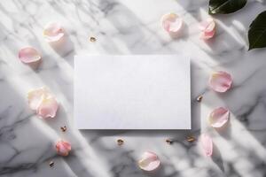 A flat lay of an embossed bridal shower invitation mockup with delicate floral patterns, surrounded by pink rose petals, gold accents, and soft shadows on a marble surface photo