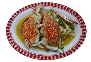 Stir Fried Blue swimming crabs with spring onion and celery Chinese wok style in oval shape plate, old style seafood menu with clipping path photo