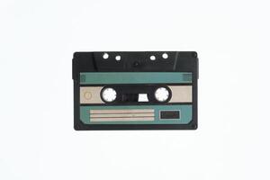 A vintage audio cassette tape with an blue and black label, isolated on a white background, evokes nostalgia and retro vibes. photo