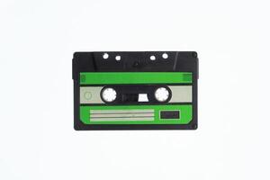 A vintage audio cassette tape with an green and black label, isolated on a white background, evokes nostalgia and retro vibes. photo