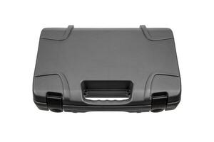 Gray, hard plastic suitcase with textured surface, handle and secure latches, isolated on white back photo