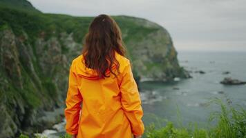 Happy Woman Traveler Walking On Mount Top And Admiring Ocean View, Back View And Portrait video