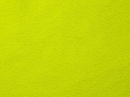 A bright green background with a yellow object in the foreground photo