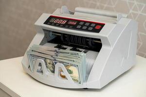 Currency counting machine in use for efficient cash handling photo
