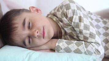 Beautiful Mom kisses a little son while he is sleeping. The son wakes up having a good mood video