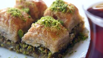 Enjoying baklava and tea in a cozy cafe setting in the afternoon video