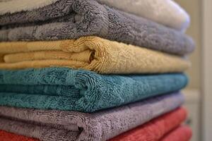 Stack of colorful and clean cotton towels folded on top of each other photo