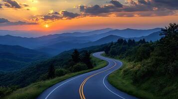 Scenic mountain road curves through rolling hills at sunset, golden sky and dramatic clouds create cinematic landscape with perfect perspective. scenic photo