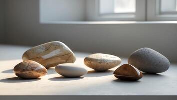 Beautifully polished stones displayed on a serene surface in natural light. photo