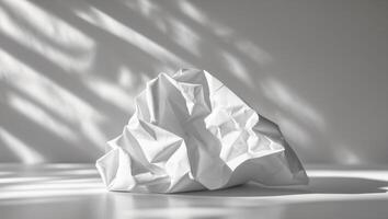 Crumpled white paper with subtle light and shadows photo