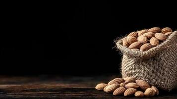 Delicious Almonds in Rustic Burlap Sack Dark Background Healthy Snack Food photo