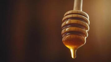 Golden Honey Dripping from Wooden Honey Dipper Close Up Studio Shot photo