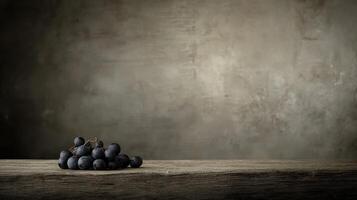 Still Life Photography Dark Grapes on Rustic Wooden Table Against Textured Background photo