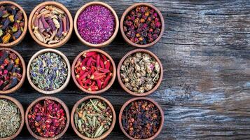 Aromatic Dried Herbs and Spices in Wooden Bowls on Rustic Wood Background photo