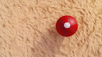 A red and white ball on the sand photo