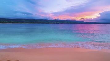 A colorful sunset over the ocean and beach photo