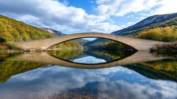 majestic stone bridge reflecting in calm lake surrounded by nature photo