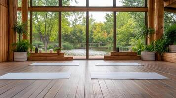 serene indoor yoga space with mats overlooking peaceful lake view photo