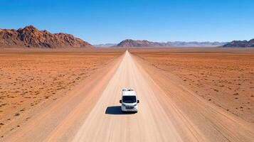 scenic desert highway with lone camper van traveling through vast landscapes photo