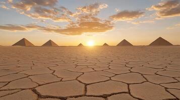 vast desert landscape with towering pyramids at sunset, creating serene atmosphere photo
