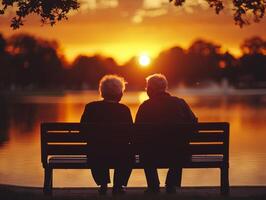 elderly Japanese couple sits closely together on wooden bench holding hands as they enjoy tranquility of serene lake sunset. warm glow enhances their intimate moment photo