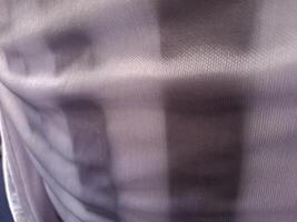 A close up of a white and black striped shirt photo