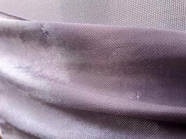 A close up of a purple fabric with holes photo